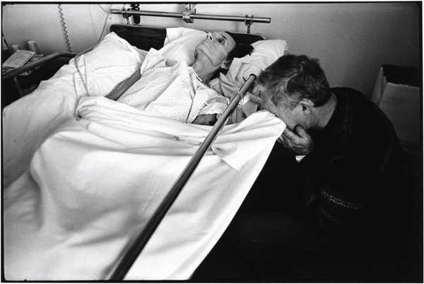 Joe is stricken with grief when visiting his partner. He cries into the bed sheet to keep his partner from seeing him. Hospice of Marin County, 1982 (Paul Fusco/Magnum Photos, 1982)
